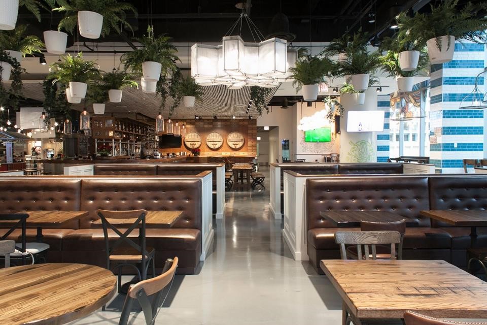 Chicago-IL-earthy-restaurant-dining-area-with-brown-tufted-booths-and-custom-wood-chairs-and-tables