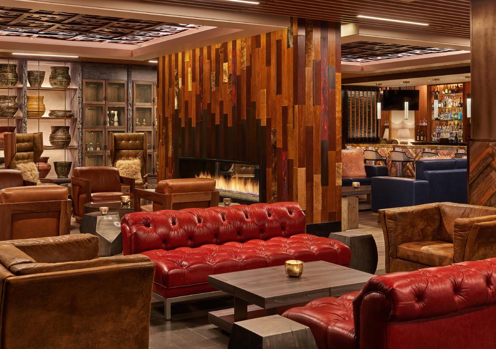hotel-lounge-area-with-fireplace-and-red-tufted-leather-commercial-seating