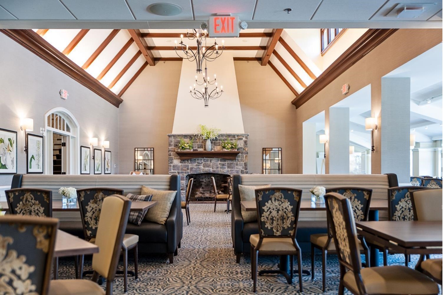 Springfield-PA-aerial-view-of-simplel-modern-commons-area-with-scattered-chairs-and-tables-mixed-with-booths-fireplace-in-background