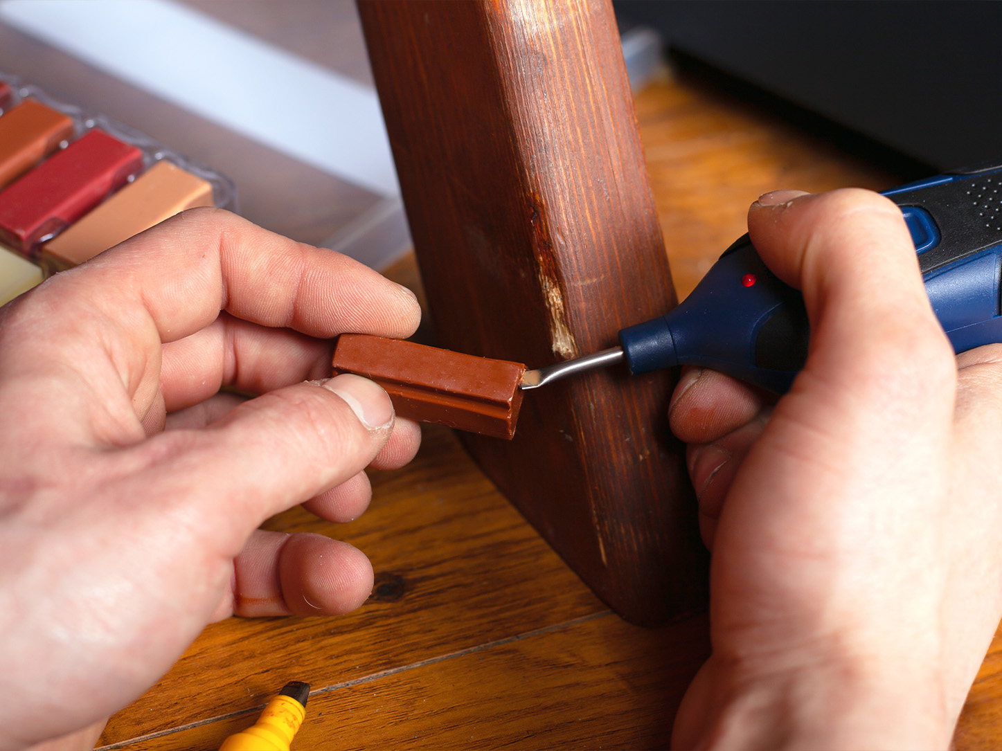 detailed-view-of-scratched-wood-furniture-getting-restored